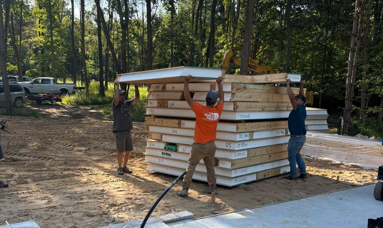 Getting organized is an important part of the job 1776 Homes Team organizing SIP wall panels